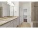Bathroom featuring double vanity with stone countertops and a large mirror at 317 Castle Rock Ln, Cary, NC 27519
