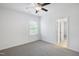 Bright bedroom with gray carpet, ceiling fan, and natural light streaming through the window at 317 Castle Rock Ln, Cary, NC 27519