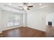 Bright bedroom with hardwood floors, white walls, and a ceiling fan at 317 Castle Rock Ln, Cary, NC 27519