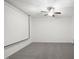 Bonus room features a ceiling fan, projector screen, and neutral carpet at 317 Castle Rock Ln, Cary, NC 27519