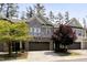 Charming townhome featuring a stone and brick facade, two-car garage, and well-manicured landscaping at 317 Castle Rock Ln, Cary, NC 27519