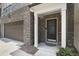 Inviting front entrance featuring a decorative black front door, brick facade, and two-car garage at 317 Castle Rock Ln, Cary, NC 27519