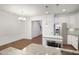 Well-lit kitchen with stainless steel appliances, granite countertops, white cabinets, and dining area at 317 Castle Rock Ln, Cary, NC 27519