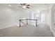 Open loft area with neutral carpet, ceiling fan, and natural light at 317 Castle Rock Ln, Cary, NC 27519