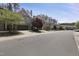 Scenic street view featuring a row of townhomes with manicured lawns and mature trees at 317 Castle Rock Ln, Cary, NC 27519