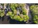 Breathtaking aerial view of the lakefront home nestled among lush greenery and a private dock at 373 & 375 Sagamore Dr, Louisburg, NC 27549