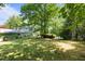 A spacious backyard with mature trees offering shade and privacy and a view of the lake at 373 & 375 Sagamore Dr, Louisburg, NC 27549