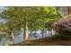 Lush backyard with mature trees and a glimpse of the lake, offering a serene and private setting at 373 & 375 Sagamore Dr, Louisburg, NC 27549