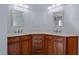 Dual sink bathroom featuring marble countertop and wood cabinets, providing ample storage at 373 & 375 Sagamore Dr, Louisburg, NC 27549