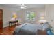 Comfortable bedroom with warm wood floors, ceiling fan and windows overlooking a lake at 373 & 375 Sagamore Dr, Louisburg, NC 27549