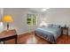 Cozy bedroom with hardwood floors, a ceiling fan, and natural light streaming through the window at 373 & 375 Sagamore Dr, Louisburg, NC 27549