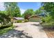 Inviting home featuring a long, private driveway leading to a spacious three car garage, all surrounded by lush landscaping at 373 & 375 Sagamore Dr, Louisburg, NC 27549