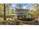 Expansive home exterior featuring large windows, stone accents, and a meticulously landscaped garden at 373 & 375 Sagamore Dr, Louisburg, NC 27549