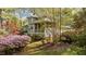 View of the house exterior with a screened-in porch, lush landscaping, and mature trees at 373 & 375 Sagamore Dr, Louisburg, NC 27549
