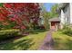 Landscaped front yard with a stone pathway leading to a charming home featuring mature trees at 373 & 375 Sagamore Dr, Louisburg, NC 27549