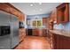 Well-appointed kitchen with custom wood cabinets, stainless steel appliances, and wood floors at 373 & 375 Sagamore Dr, Louisburg, NC 27549
