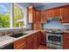 Close-up of a kitchen featuring custom cabinets, granite countertops, and stainless steel appliances at 373 & 375 Sagamore Dr, Louisburg, NC 27549