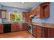 Charming kitchen featuring wood cabinets, stainless steel appliances, and a bright window view at 373 & 375 Sagamore Dr, Louisburg, NC 27549