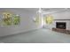 Spacious living room with a fireplace and three windows showcasing the natural landscape at 373 & 375 Sagamore Dr, Louisburg, NC 27549