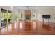 Bright living room showcasing hardwood floors, a stone fireplace, and scenic outdoor views at 373 & 375 Sagamore Dr, Louisburg, NC 27549