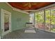 Relaxing covered porch with a swing, wood ceiling with fan, overlooking serene outdoor scenery at 373 & 375 Sagamore Dr, Louisburg, NC 27549