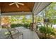 Covered porch with stone columns, outdoor furniture, and views of the lake at 373 & 375 Sagamore Dr, Louisburg, NC 27549