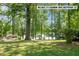 Large, grassy lot with a view of the lake and mature trees offering privacy at 373 & 375 Sagamore Dr, Louisburg, NC 27549