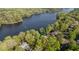 Scenic aerial perspective of a lakeside property embraced by verdant foliage, showcasing its tranquil setting and waterfront charm at 373 Sagamore Dr, Louisburg, NC 27549