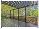 Spacious wooden back deck with a pergola, perfect for outdoor entertaining and relaxation at 4 N Poston Ct, Durham, NC 27705