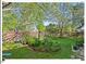 Beautifully landscaped backyard with vibrant plants and a stone path at 4 N Poston Ct, Durham, NC 27705