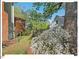 Scenic backyard featuring a lush flower bed, a deck with wooden latticework and mature trees at 4 N Poston Ct, Durham, NC 27705