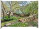 Charming backyard with wooden bridge feature, deck with pergola, and beautiful garden at 4 N Poston Ct, Durham, NC 27705
