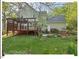 Expansive backyard with a deck, lush lawn and mature trees at 4 N Poston Ct, Durham, NC 27705