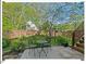 Inviting backyard patio with outdoor seating, surrounded by lush landscaping and mature trees at 4 N Poston Ct, Durham, NC 27705