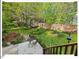 Tranquil backyard with landscaping, a seating area, mature trees, and a trampoline at 4 N Poston Ct, Durham, NC 27705