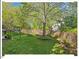Expansive backyard featuring a lush lawn, mature trees, and beautiful landscaping around the home at 4 N Poston Ct, Durham, NC 27705