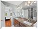 Well-lit bathroom with dual sink vanity and a view into an adjacent bedroom at 4 N Poston Ct, Durham, NC 27705