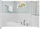 Luxurious soaking tub with white subway tile surround and stylish fixtures at 4 N Poston Ct, Durham, NC 27705