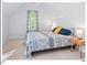 Comfortable bedroom with neutral tones and a patterned blue and white bedspread at 4 N Poston Ct, Durham, NC 27705