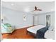 Spacious bedroom with hardwood floors, ceiling fan, and a comfortable sitting area at 4 N Poston Ct, Durham, NC 27705