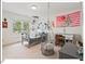 Well-lit bedroom with whimsical decor, a swing chair, and a view of outside greenery at 4 N Poston Ct, Durham, NC 27705
