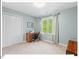 Clean bedroom with natural light, a sewing machine desk, and double door closet at 4 N Poston Ct, Durham, NC 27705