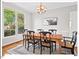 Elegant dining room featuring a wooden table, six chairs, and a large window at 4 N Poston Ct, Durham, NC 27705