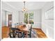Bright dining room with hardwood floors, a wooden table, and a large window at 4 N Poston Ct, Durham, NC 27705