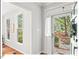 Bright entryway featuring hardwood floors, white trim, and views of the landscaped front yard at 4 N Poston Ct, Durham, NC 27705