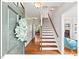 Welcoming entryway with hardwood floors, staircase, and view into adjacent rooms at 4 N Poston Ct, Durham, NC 27705