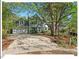 Charming two-story home with a well-manicured front lawn and mature trees providing ample shade at 4 N Poston Ct, Durham, NC 27705