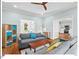 Light-filled living room has wood floors, and access to the kitchen and outdoor views at 4 N Poston Ct, Durham, NC 27705