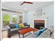 Bright living room features a fireplace, hardwood floors, and access to the outdoor deck at 4 N Poston Ct, Durham, NC 27705