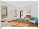 Cozy living room featuring hardwood floors, a futon, and large windows at 4 N Poston Ct, Durham, NC 27705